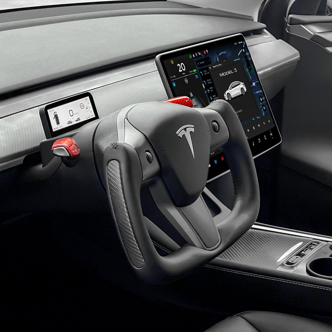 Sea Dragon Dreams carbon fiber yoke steering wheel installed in a Tesla Model 3 interior with red accent buttons.