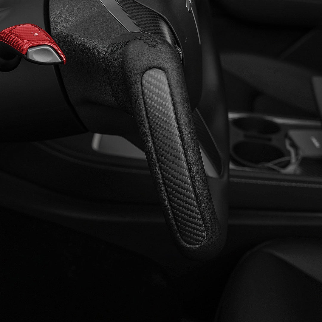 Sea Dragon Dreams carbon fiber yoke steering wheel with red paddle shifter installed in a Tesla Model 3 or Model Y.