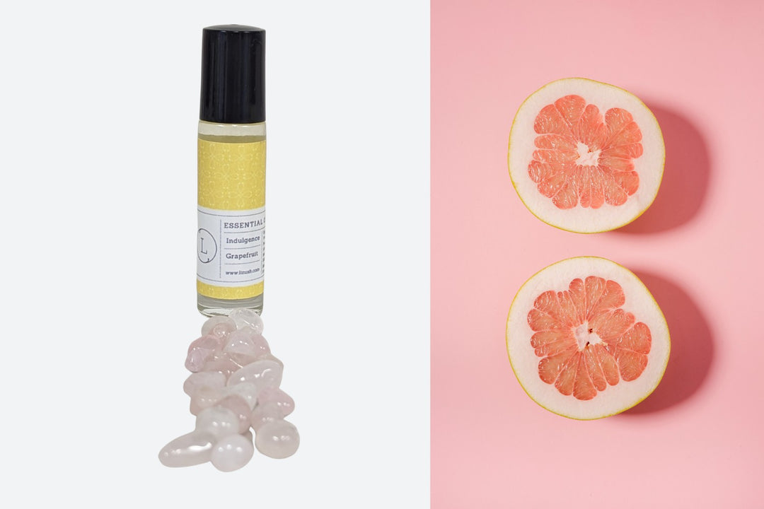 Sea Dragon Dreams grapefruit essential oil roll-on with CBD isolate and tumbled crystals next to fresh grapefruit slices