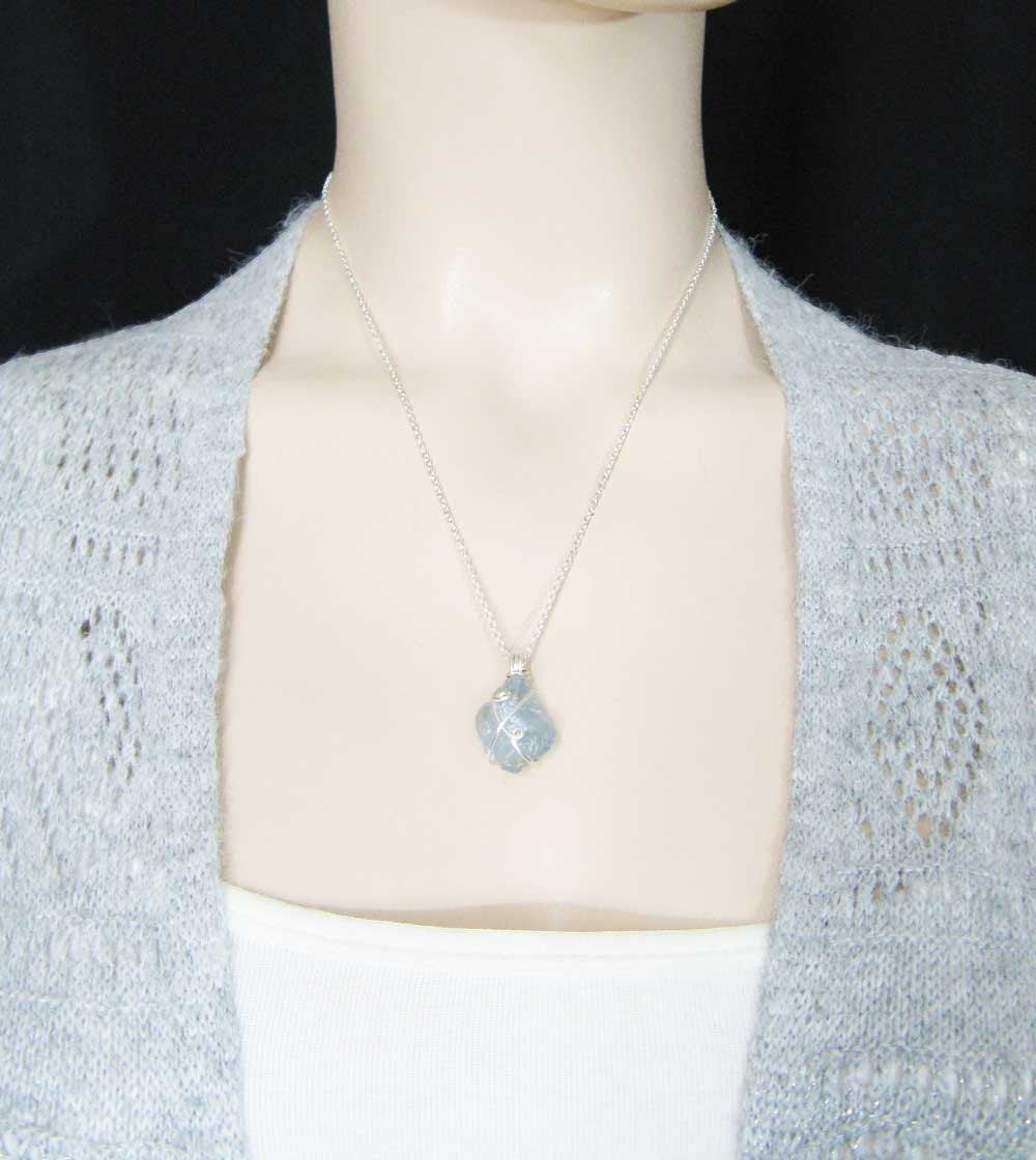 Sea Dragon Dreams handmade raw sky-blue celestite crystal pendant necklace with silver-plated wire wrapping on a model