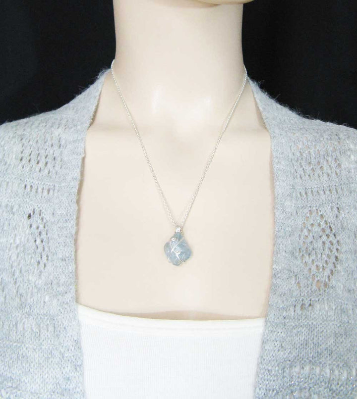 Sea Dragon Dreams handmade raw sky-blue celestite crystal pendant necklace with silver-plated wire wrapping on a model