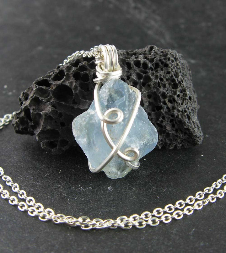 Sea Dragon Dreams raw sky-blue celestite crystal pendant in silver-plated wire wrapping on a delicate chain.