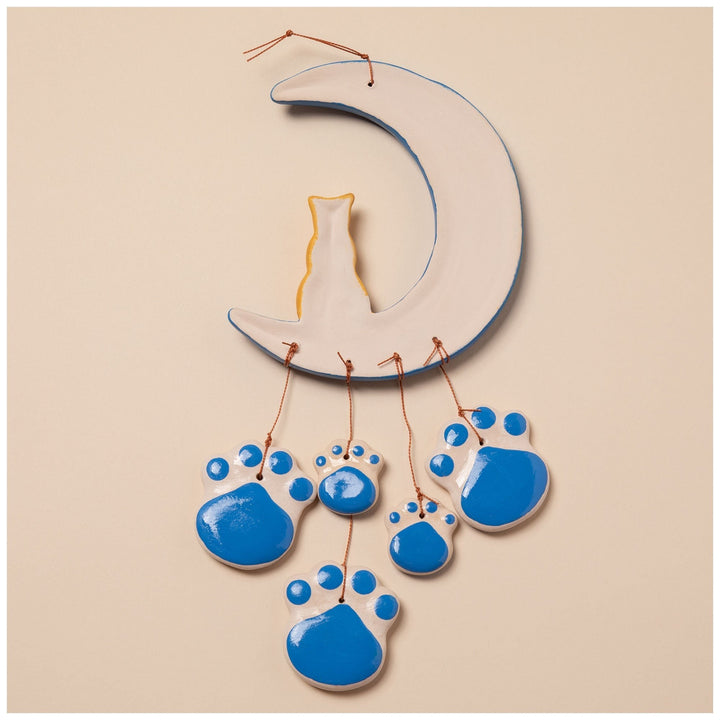 Sea Dragon Dreams handmade ceramic wind chime featuring a cat sitting on a moon with blue paw print accents.