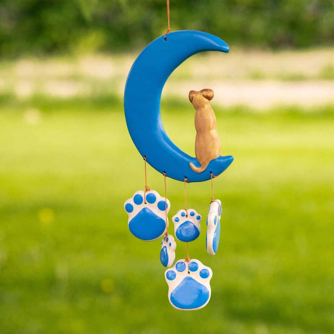 Sea Dragon Dreams handmade ceramic wind chime featuring a blue crescent moon with a cat and hanging paw print charms.
