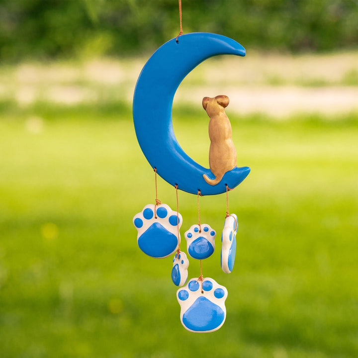 Sea Dragon Dreams handmade ceramic wind chime featuring a blue crescent moon with a cat and hanging paw print charms.