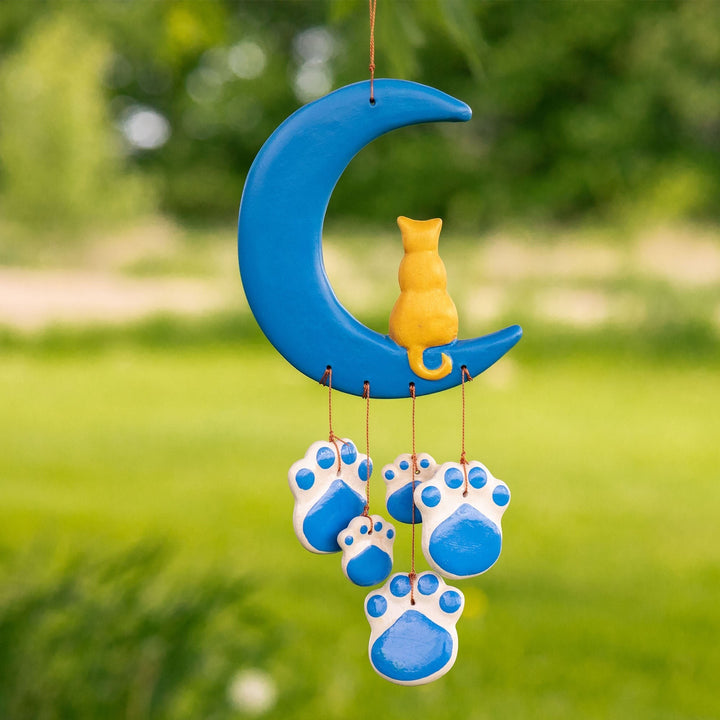 Sea Dragon Dreams handmade ceramic wind chime featuring a blue crescent moon, yellow cat, and blue paw print charms.