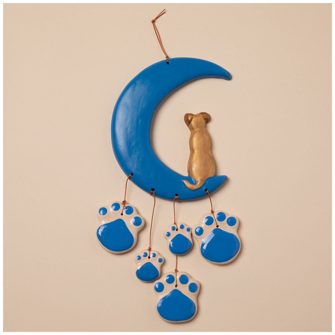 Sea Dragon Dreams handmade ceramic wind chime featuring a blue crescent moon with a gold dog and blue paw print charms