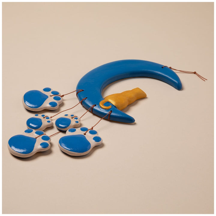Sea Dragon Dreams handmade ceramic wind chime featuring a blue crescent moon and dangling blue paw print charms.