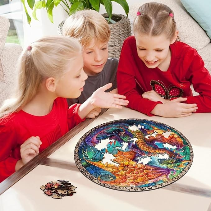 Three children smiling while assembling a Sea Dragon Dreams 500-piece circular wooden dragon puzzle on a table.