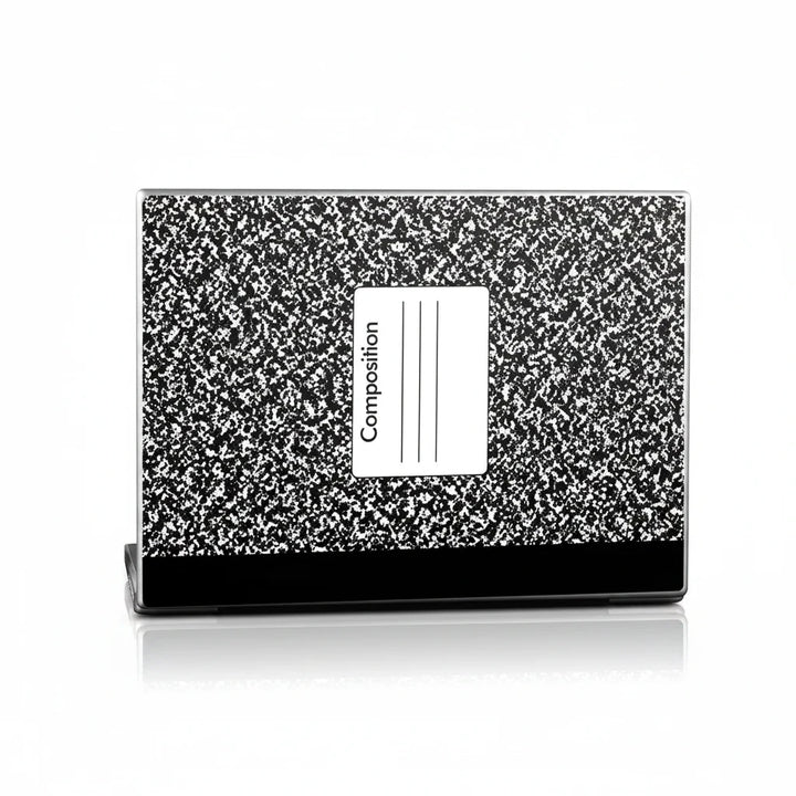 Sea Dragon Dreams composition notebook laptop skin with classic black and white speckled pattern and label detail.