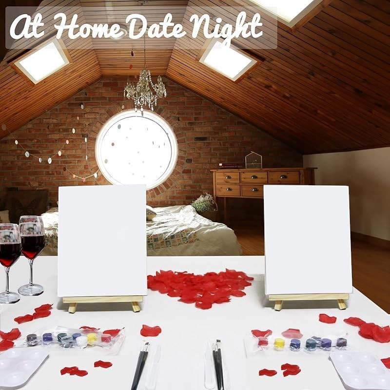 Sea Dragon Dreams couples sip and paint kit with two blank canvases, easels, acrylic paints, and rose petals on table