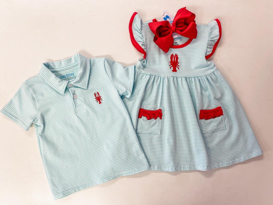 Sea Dragon Dreams baby crawfish outfit set with aqua striped polo shirt and flutter sleeve dress with red trim.