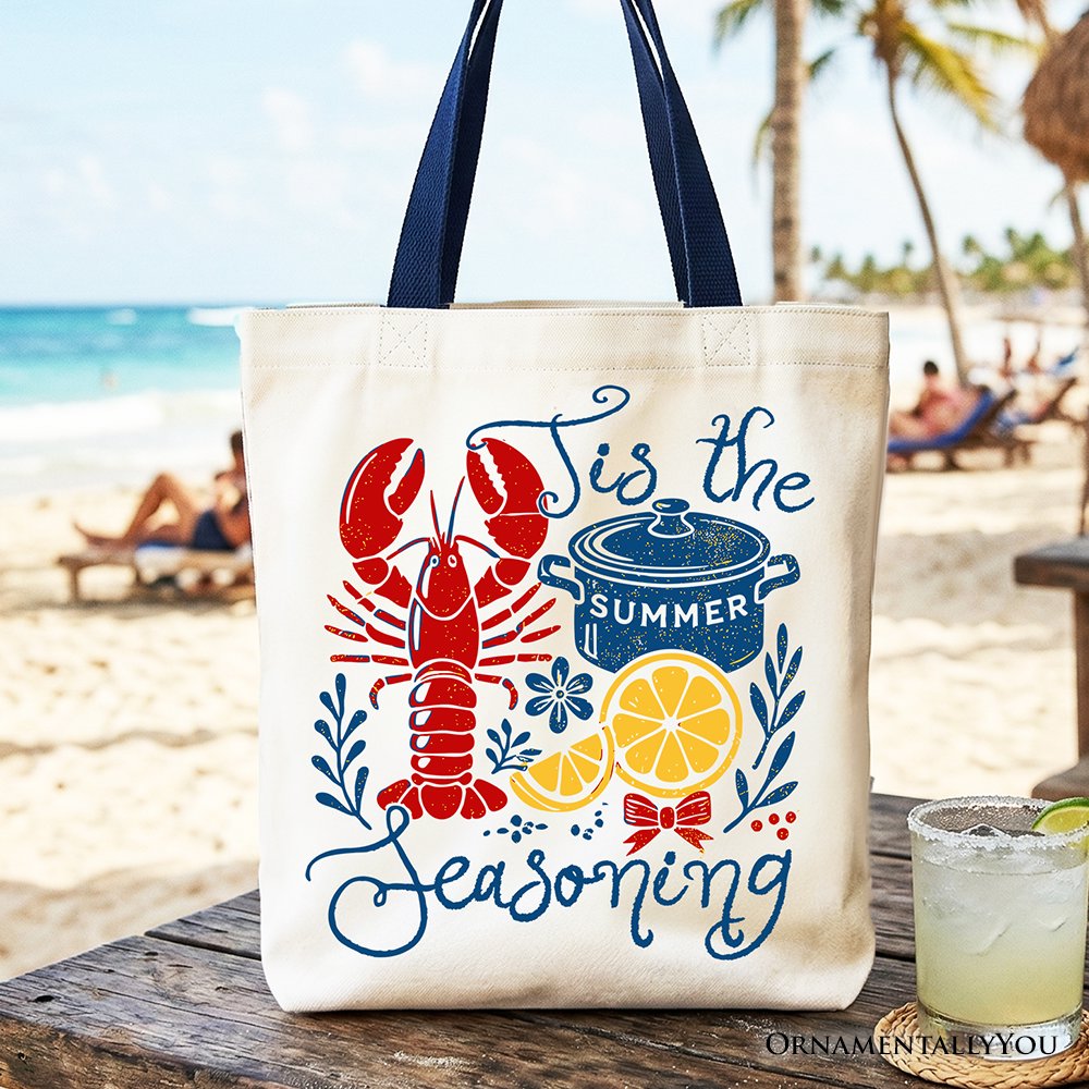 Sea Dragon Dreams canvas tote bag with retro crawfish boil print, featuring a lobster, pot, and lemon on a beach.
