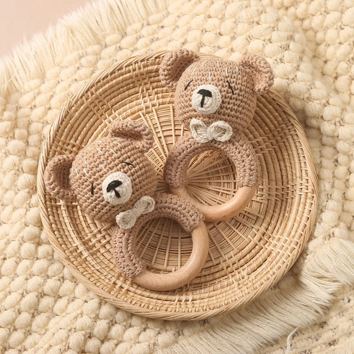 Sea Dragon Dreams crochet bear rattles with wooden rings on a woven basket, perfect for sensory play and teething.