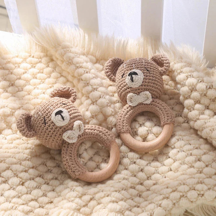 Sea Dragon Dreams crochet bear rattles with wooden teething rings on a soft cream textured blanket