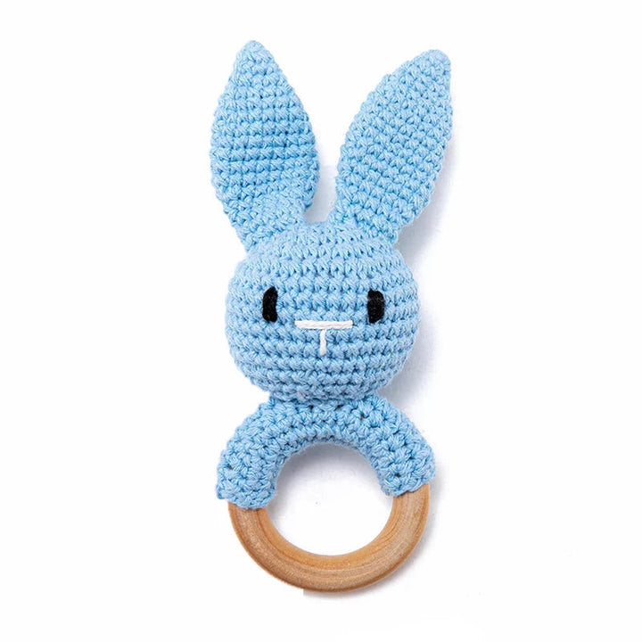 Sea Dragon Dreams blue crochet bunny rattle with a natural wooden teether ring for infants and sensory play.