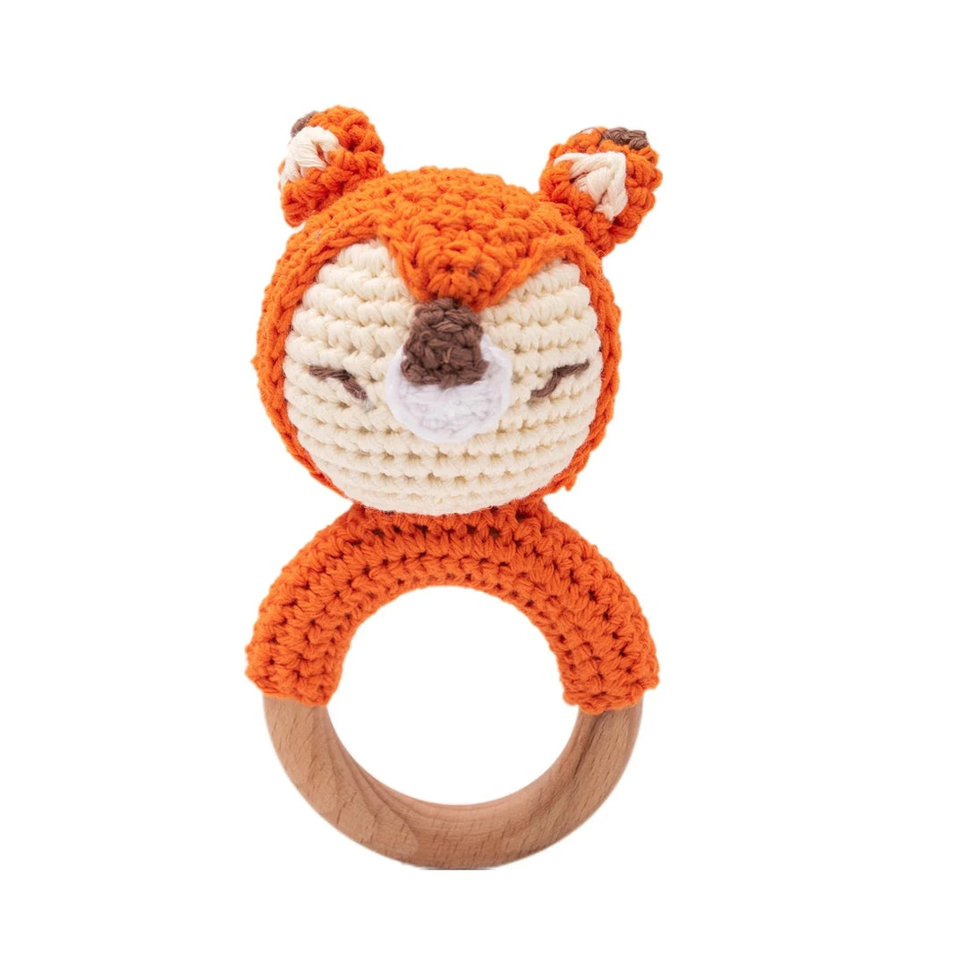 Sea Dragon Dreams crochet fox baby rattle with a wooden teether ring, featuring soft orange and cream cotton yarn.