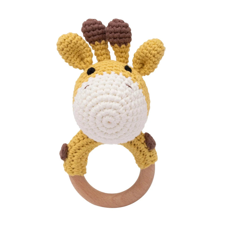Sea Dragon Dreams crochet giraffe baby rattle with a wooden teether ring, featuring soft yellow and brown cotton yarn.