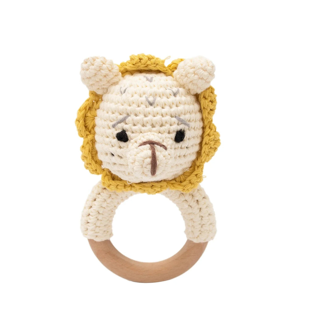 Sea Dragon Dreams crochet lion baby rattle with a wooden teether ring, featuring soft cream and yellow cotton yarn.