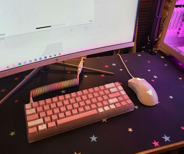Sea Dragon Dreams custom XL desk mat with a black star pattern under a pink mechanical keyboard and white mouse.