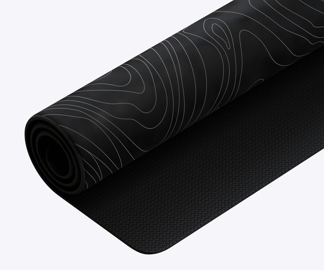 Sea Dragon Dreams custom XL desk mat with a black and white topographic line pattern and non-slip rubber base.