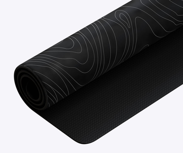 Sea Dragon Dreams custom XL desk mat with a black and white topographic line pattern and non-slip rubber base.
