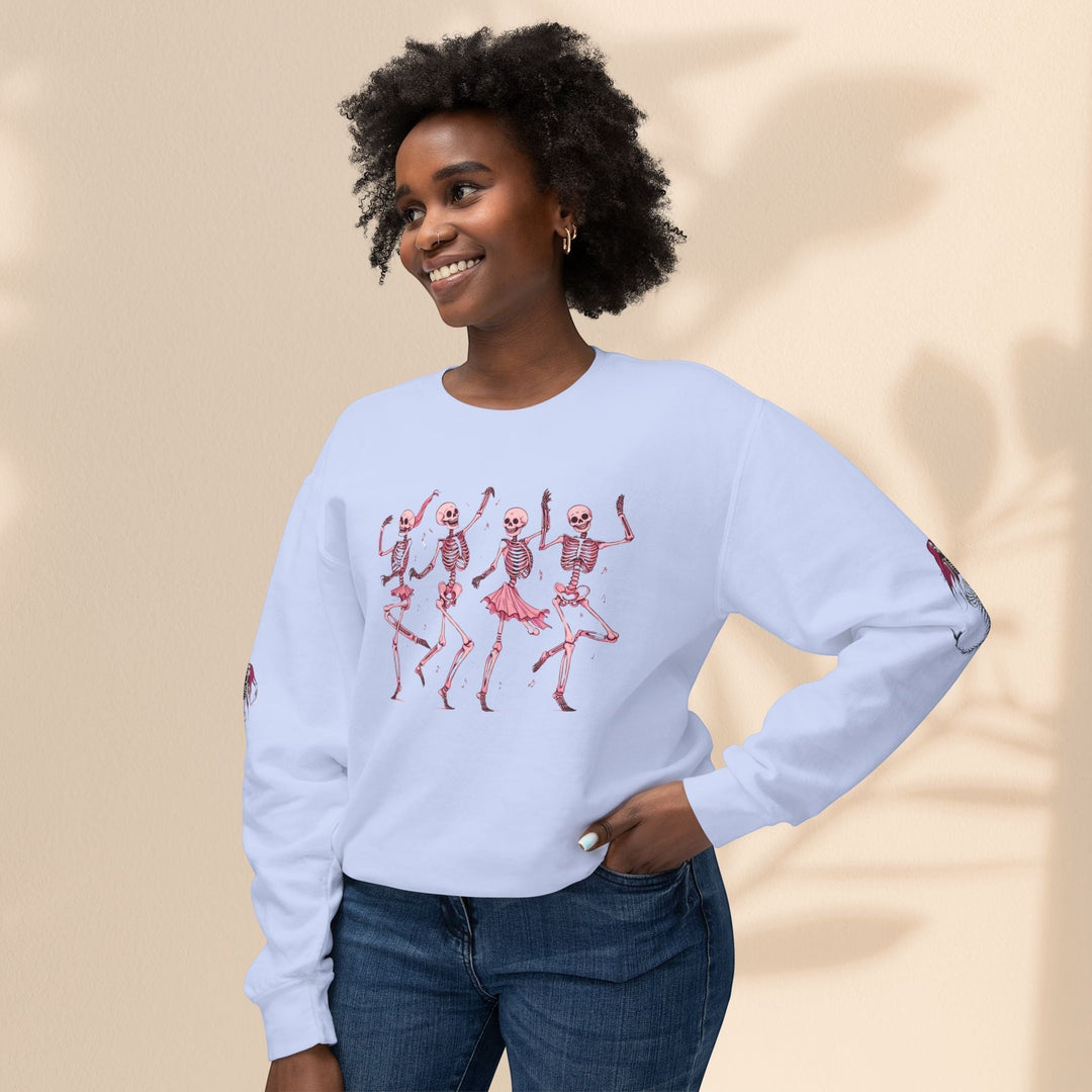 Model wearing a Sea Dragon Dreams light blue crewneck sweatshirt with a pink dancing skeletons graphic print.