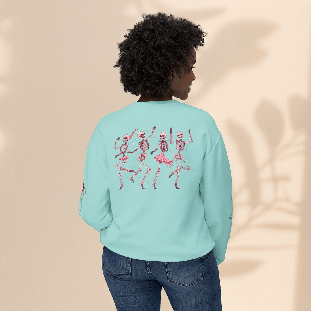 Sea Dragon Dreams light blue crewneck sweatshirt featuring a back print of four dancing skeletons in pink tutus.