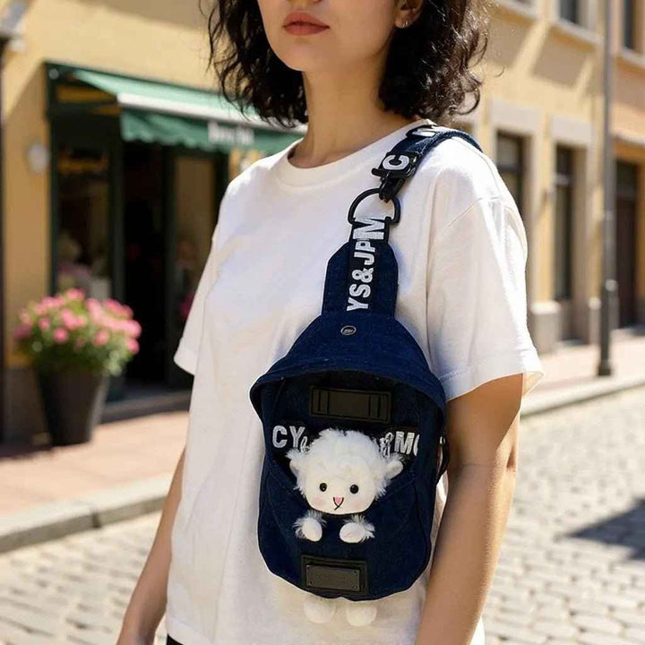 Sea Dragon Dreams kawaii denim crossbody sling bag with a cute sheep charm worn by a woman on a sunny street.
