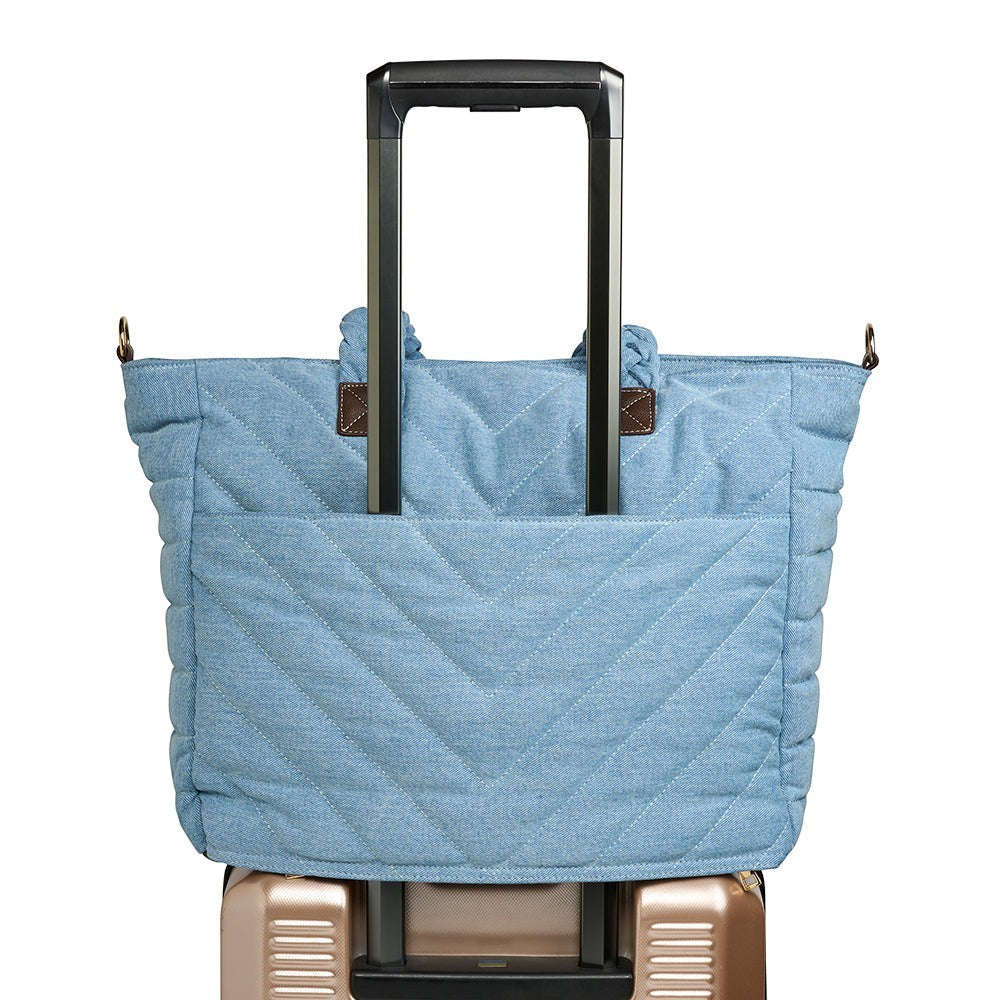 Sea Dragon Dreams blue quilted denim HydroTote bag featuring a luggage sleeve attached to a suitcase handle.