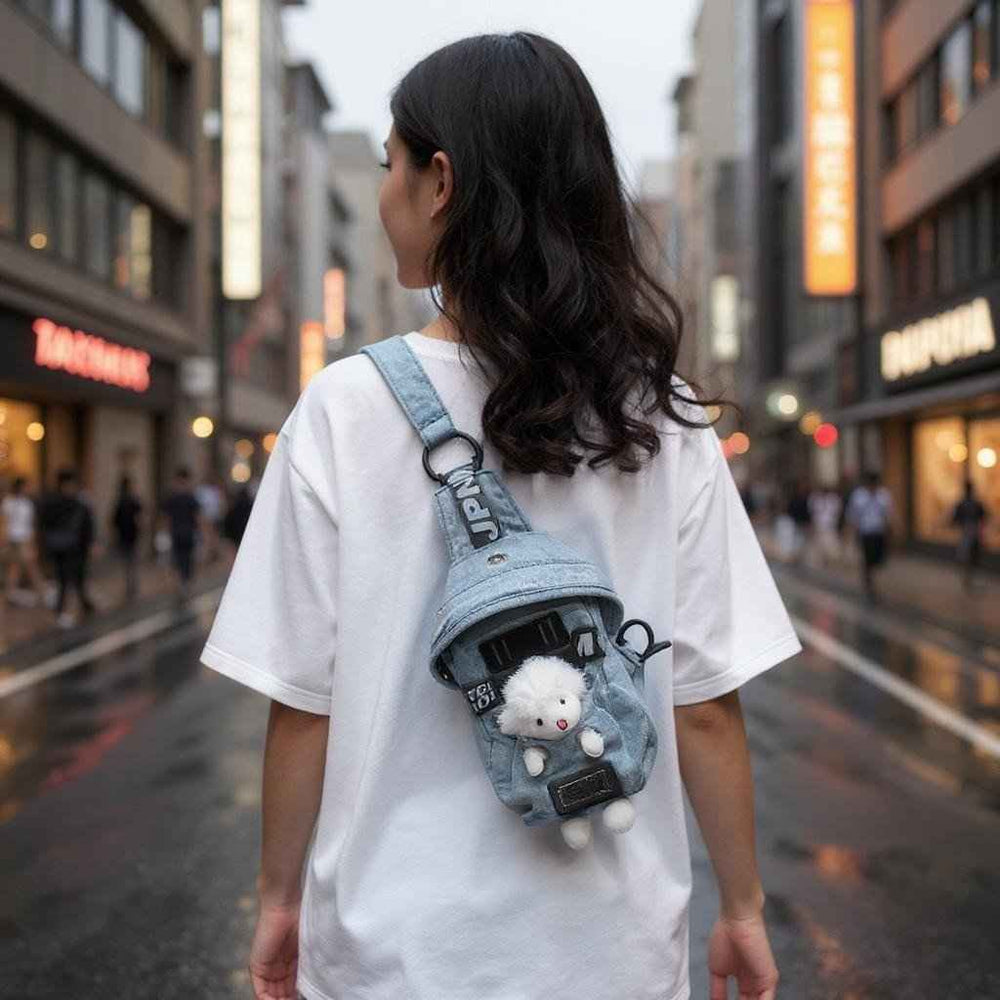 Sea Dragon Dreams kawaii denim crossbody sling bag with a cute sheep charm worn by a woman on a city street.