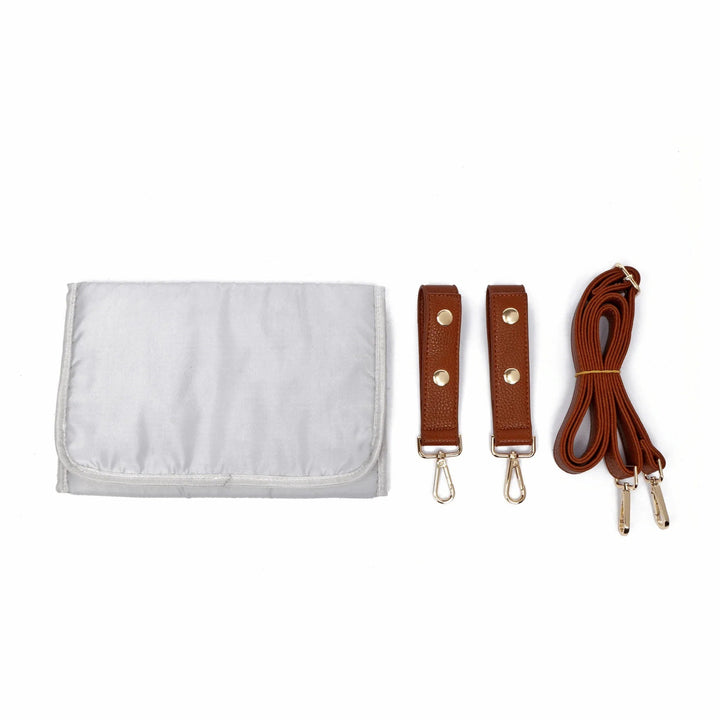 Sea Dragon Dreams Signature diaper bag accessories including a grey changing pad, caramel stroller straps, and strap.