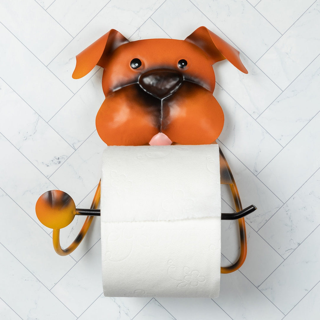 Sea Dragon Dreams metal dog-shaped toilet paper holder in orange and brown, mounted on a white herringbone tile wall.