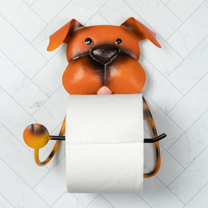 Sea Dragon Dreams metal dog-shaped toilet paper holder in orange and brown, mounted on a white herringbone tile wall.