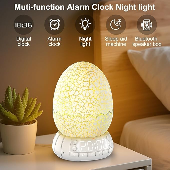 Sea Dragon Dreams dragon egg alarm clock with sunrise night light, Bluetooth speaker, and digital display on a desk.