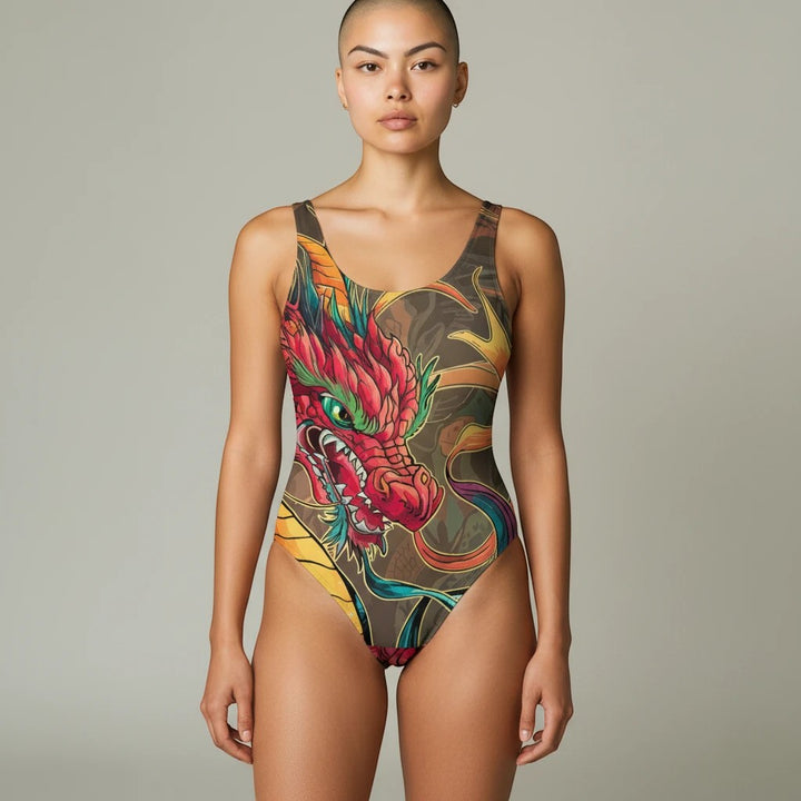 Model wearing a Sea Dragon Dreams one-piece swimsuit featuring a vibrant red and orange dragon print on brown fabric.