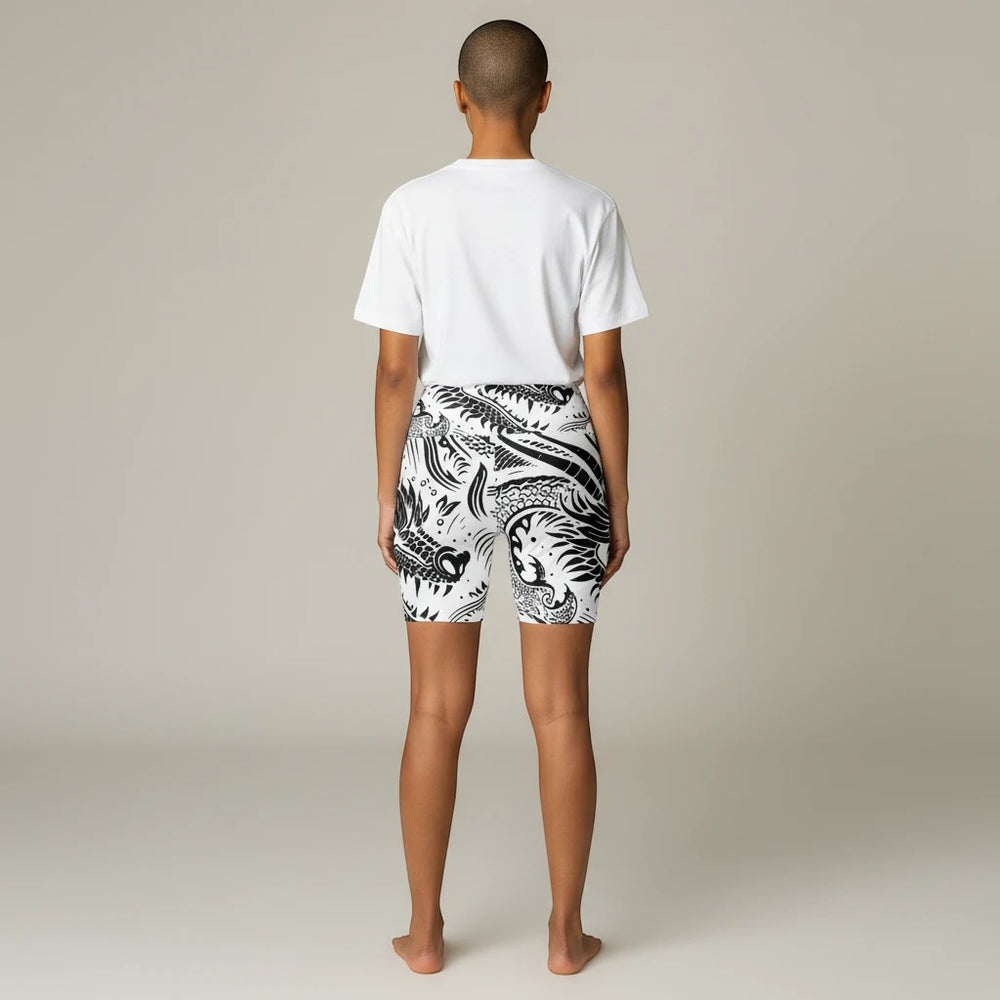 Back view of a woman wearing Sea Dragon Dreams black and white dragon print polyester workout shorts