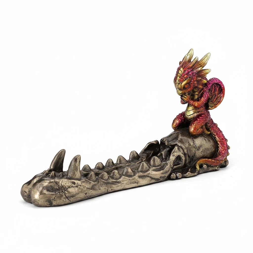 Sea Dragon Dreams cold cast bronze incense burner featuring a ruby and gold baby dragon perched on a skull