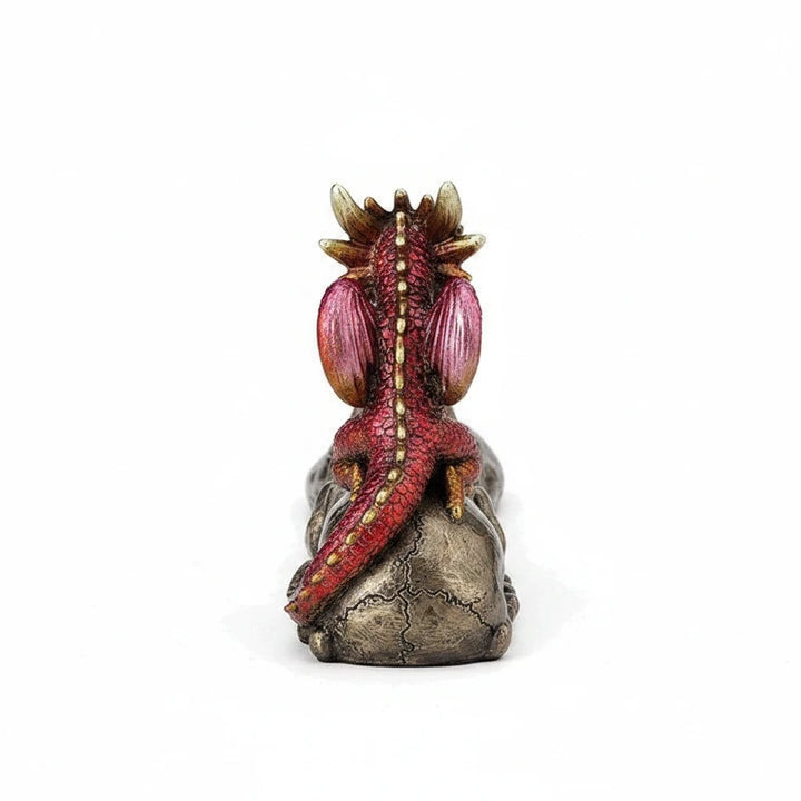 Sea Dragon Dreams cold cast bronze incense burner featuring a ruby and gold baby dragon perched on a skull