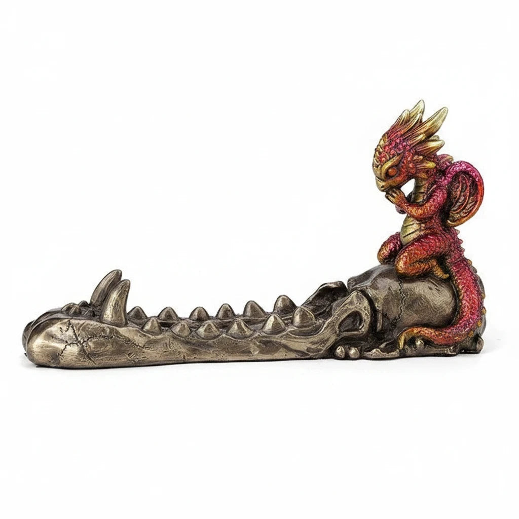 Sea Dragon Dreams cold cast bronze incense burner featuring a ruby and gold baby dragon perched on a skull.