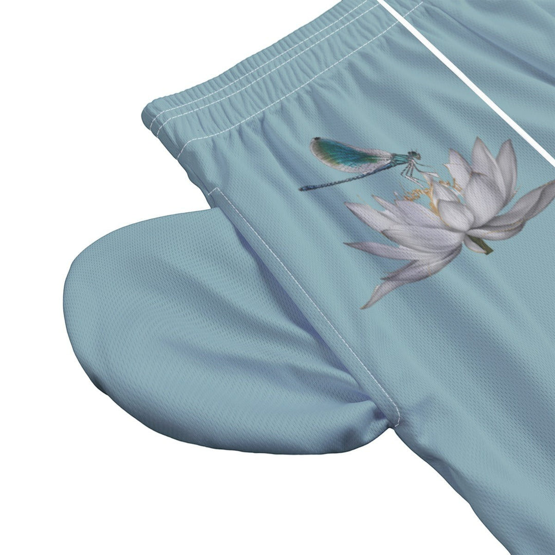 Sea Dragon Dreams men's light blue swim shorts featuring a detailed dragonfly and white lotus flower print