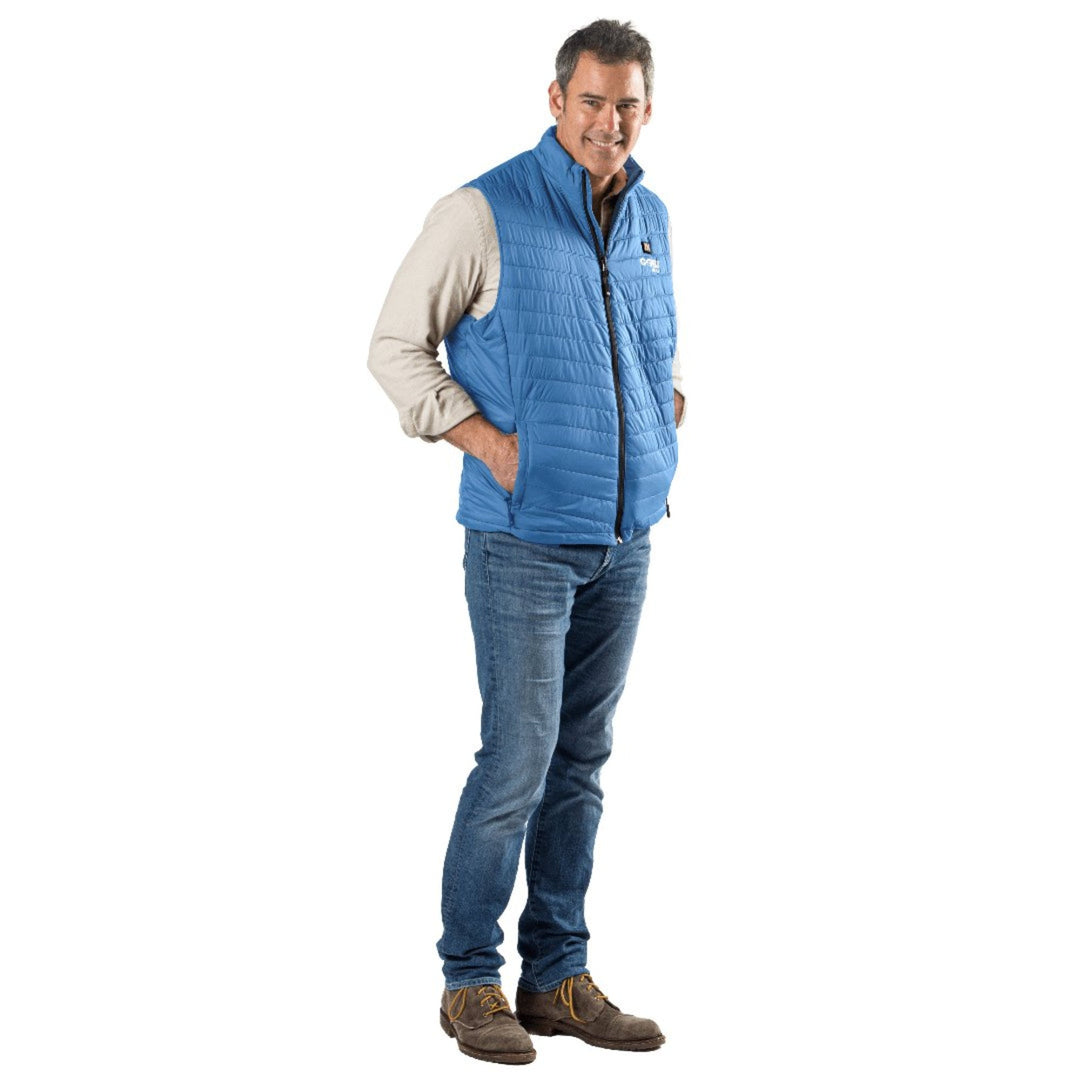 Man wearing a blue Sea Dragon Dreams Dune heated vest over a beige shirt and jeans, showing a modern quilted design.
