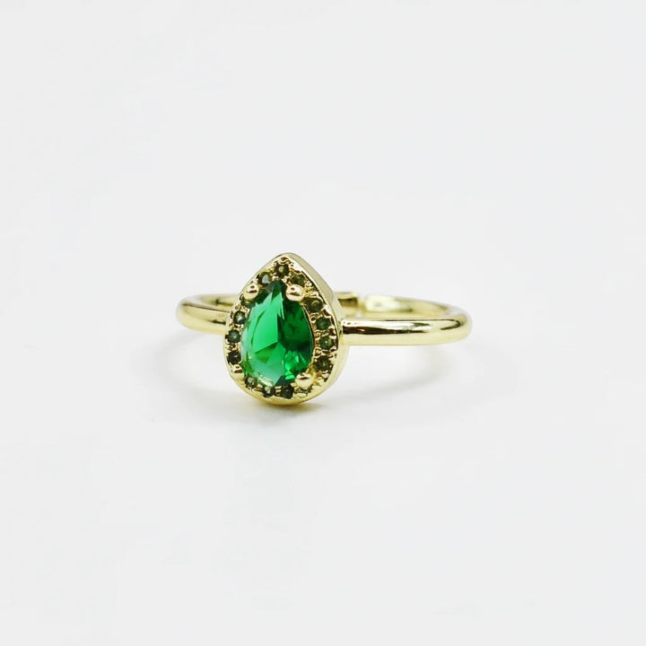 Sea Dragon Dreams adjustable gold-tone ring featuring a teardrop-shaped emerald green crystal centerpiece.