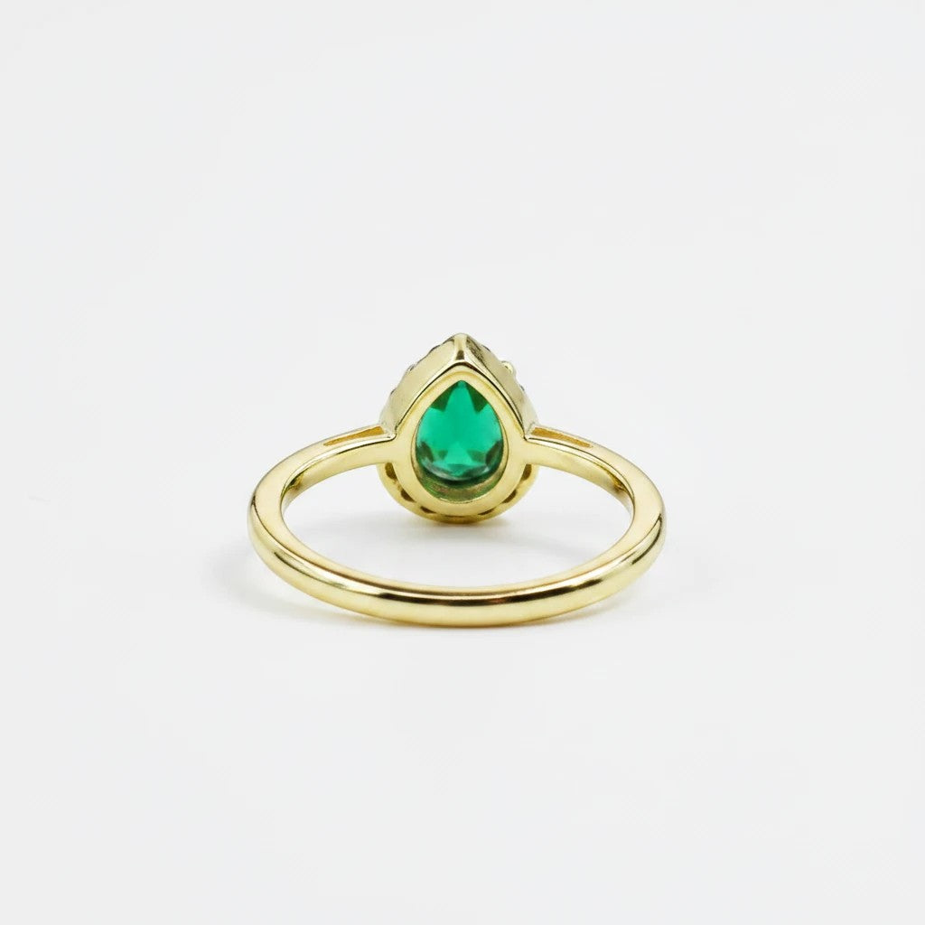 Sea Dragon Dreams adjustable gold tone ring featuring an emerald green teardrop crystal centerpiece