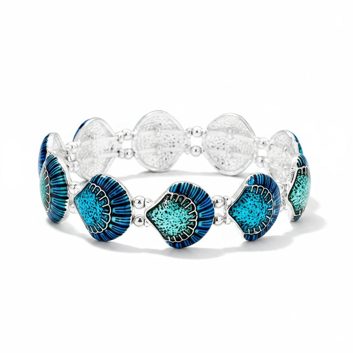 Sea Dragon Dreams enamel shell stretch bracelet featuring vibrant blue and teal shell charms on a silver metal band.