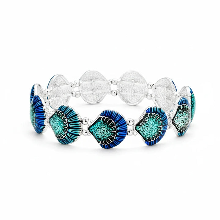 Sea Dragon Dreams enamel shell stretch bracelet featuring blue and teal shell charms on a silver metal band.