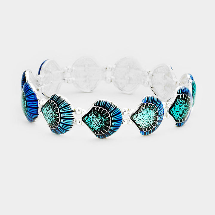 Sea Dragon Dreams enamel shell stretch bracelet featuring vibrant blue and teal coastal shell charms on a metal band.