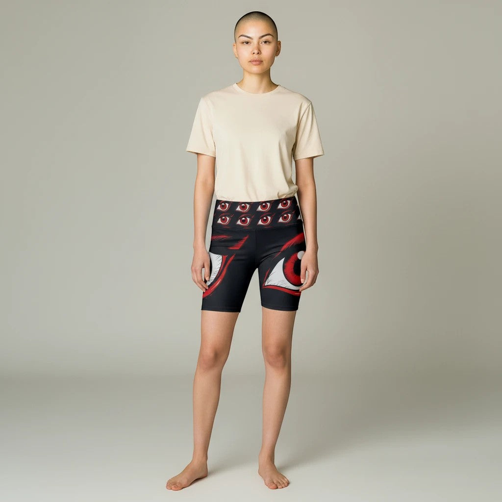 Model wearing Sea Dragon Dreams I'm Watching workout shorts with red eye print on black polyester fabric