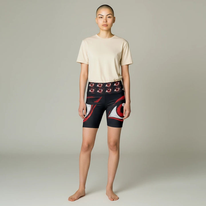 Model wearing Sea Dragon Dreams I'm Watching workout shorts with red eye print on black polyester fabric