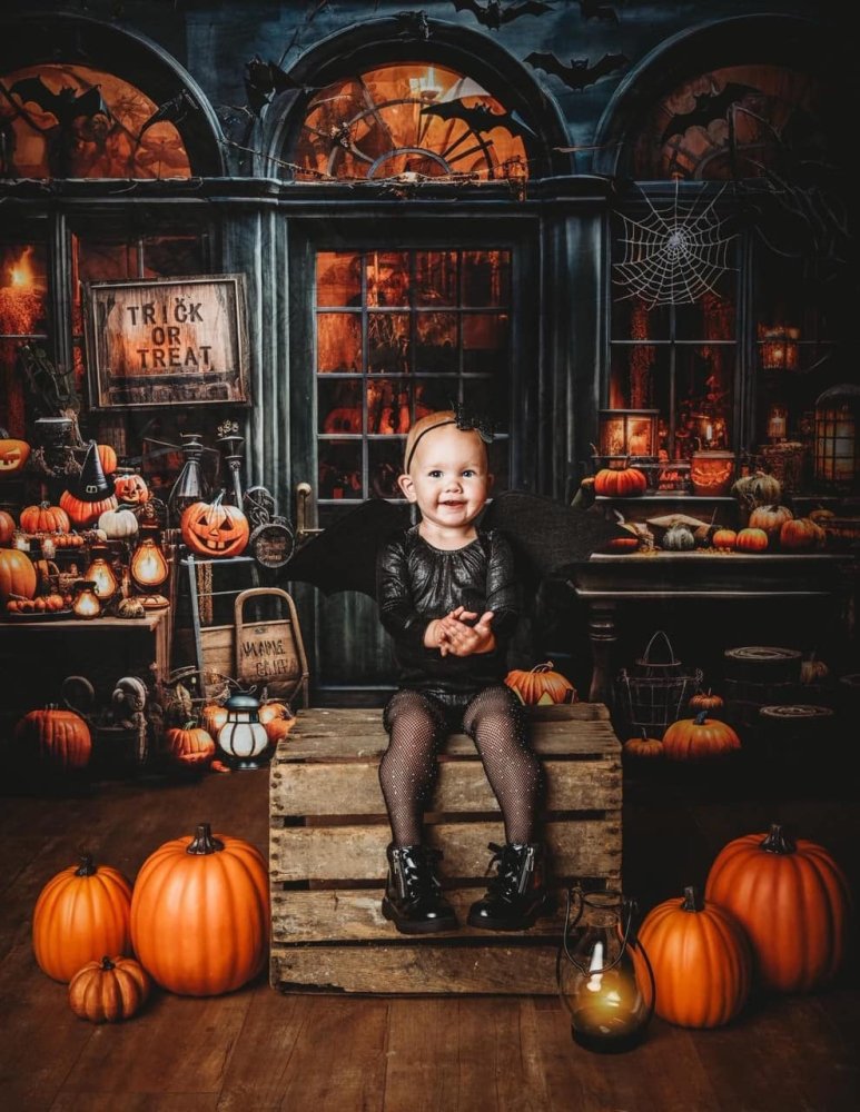 Sea Dragon Dreams felt bat wings worn by a toddler in a Halloween-themed setting with pumpkins and lanterns.